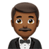 🤵🏾‍♂️ man in tuxedo: medium-dark skin tone display on Apple